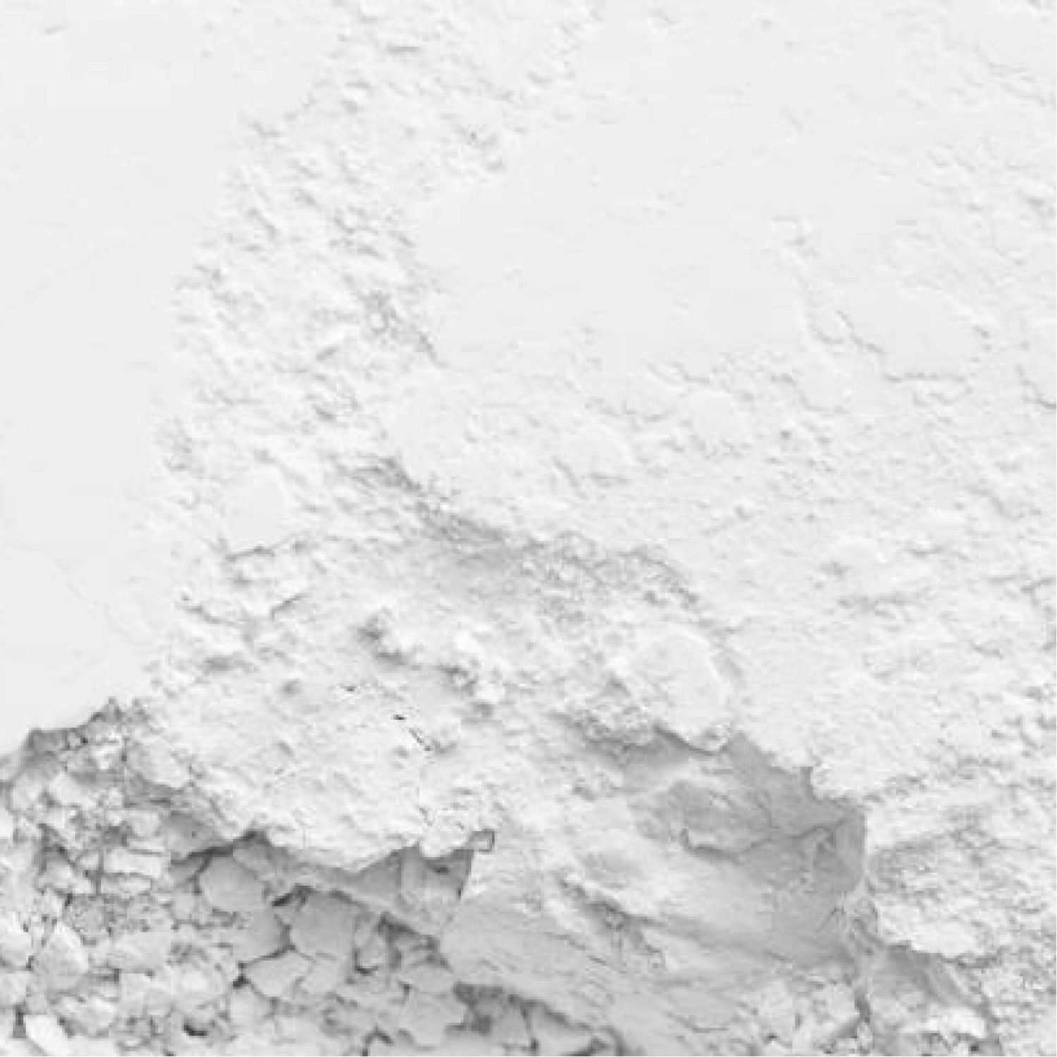 Close-up of white flour scattered on a surface.