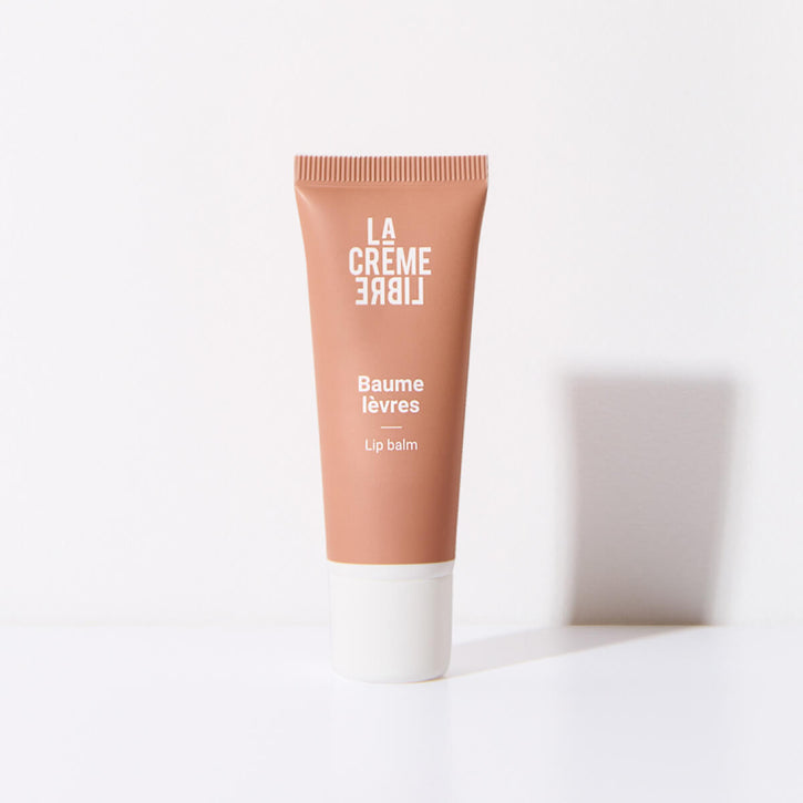 A tube of La Crème Libre lip balm on a white background.