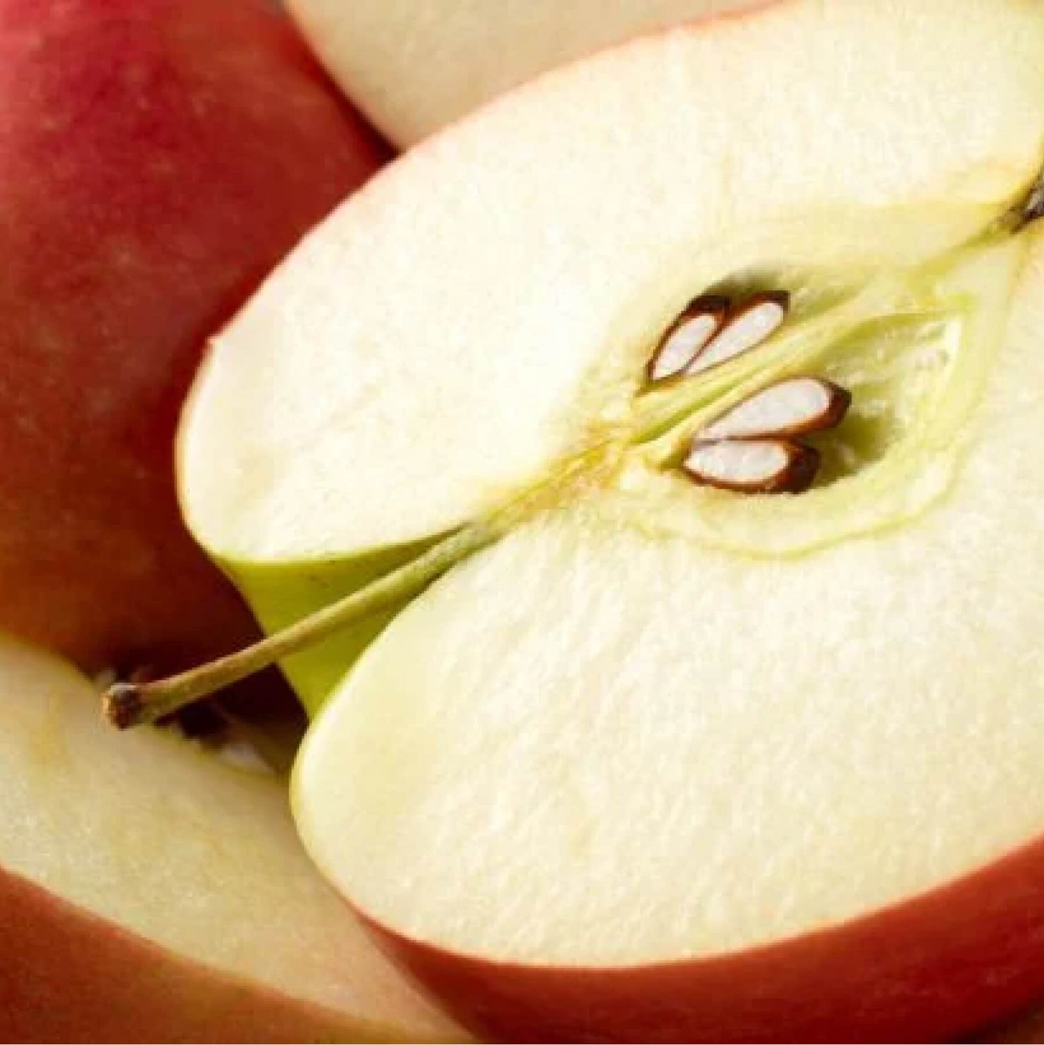 Close-up of a green apple with water droplets.